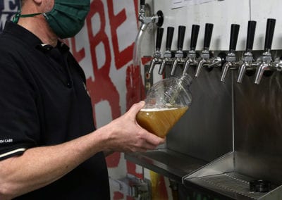 Delmar Beverage employee pouring beer